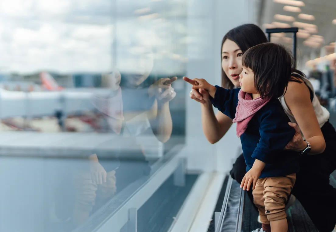Mother and child looking out of an aircraft window